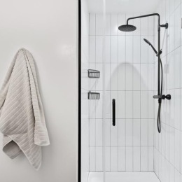 Experience luxury in every detail at The Wilmore a glass shower with black hardware